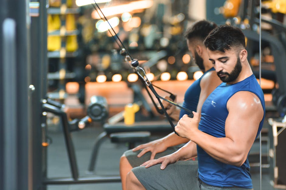 Man in blue activewear performing cable workout in a fitness gym in Antalya, Turkey